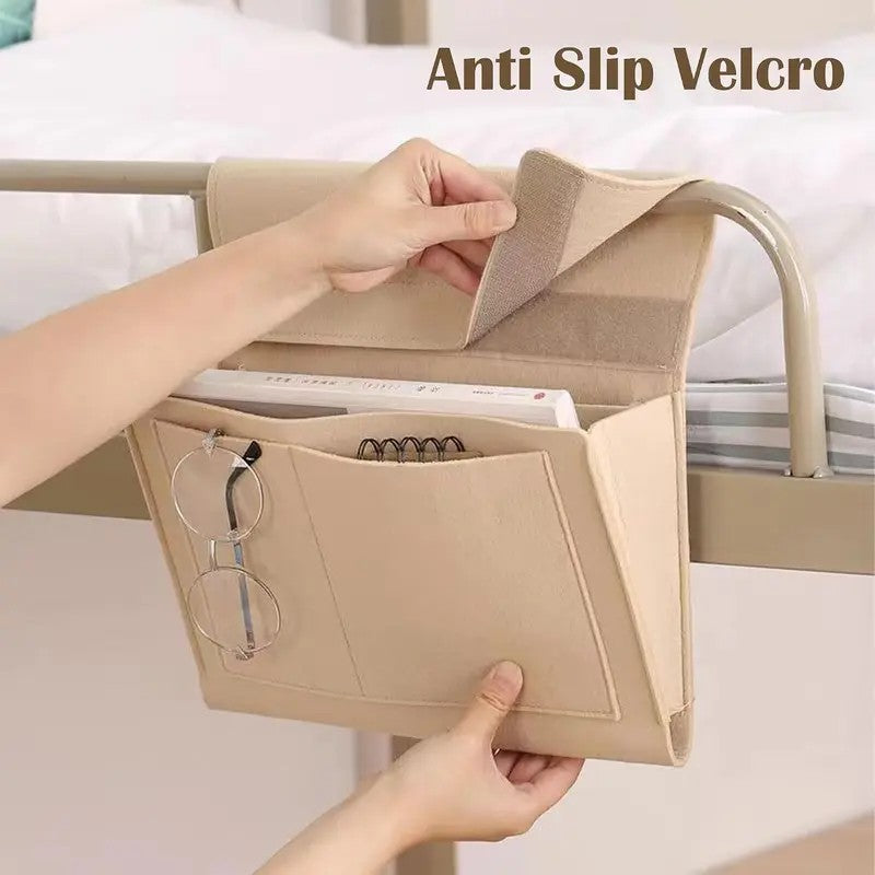 Anti-slip hook-and-loop flap securing the beige bedside caddy around a metal bed rail